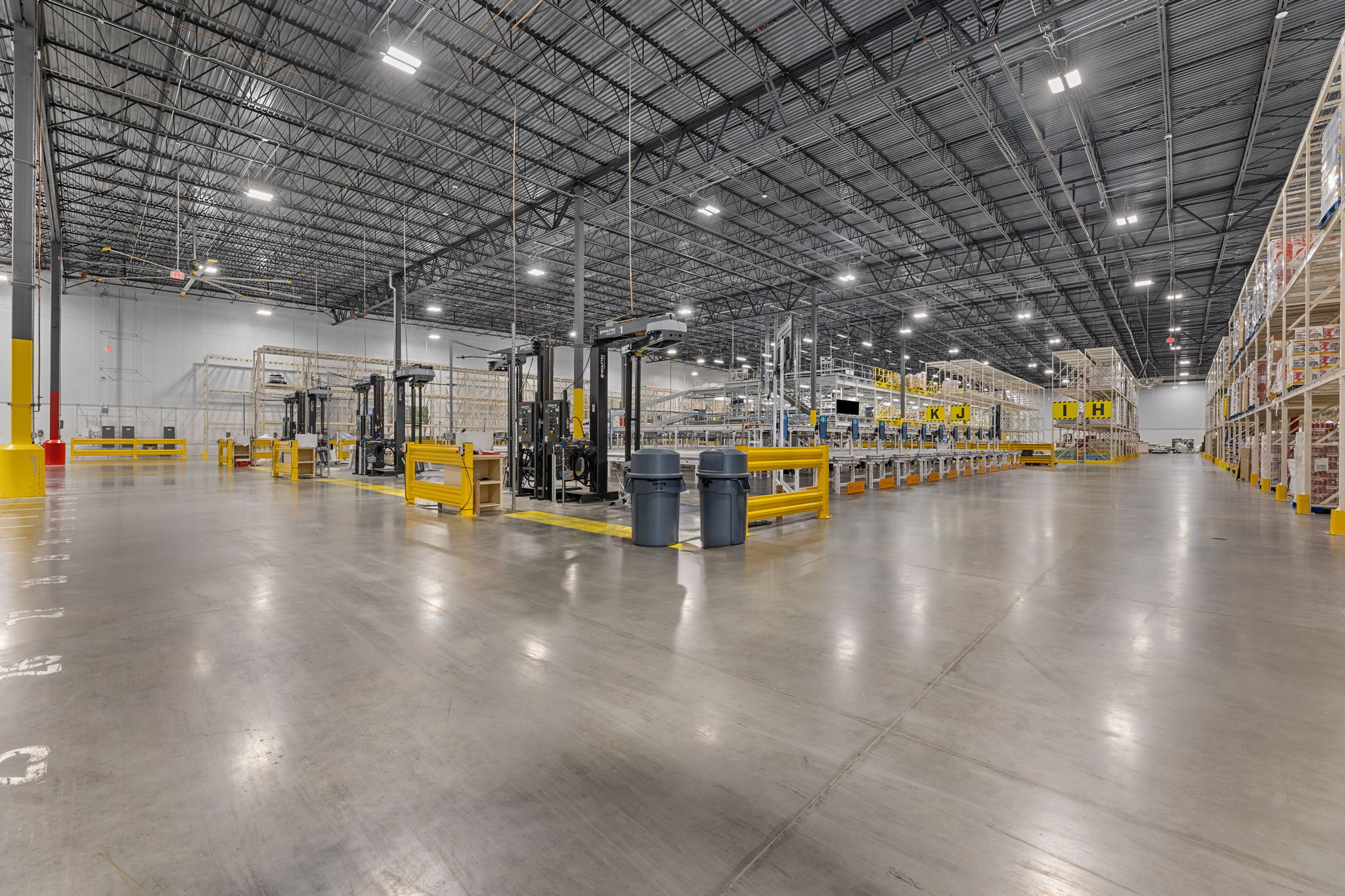 Warehouse interior with racks and equipment.