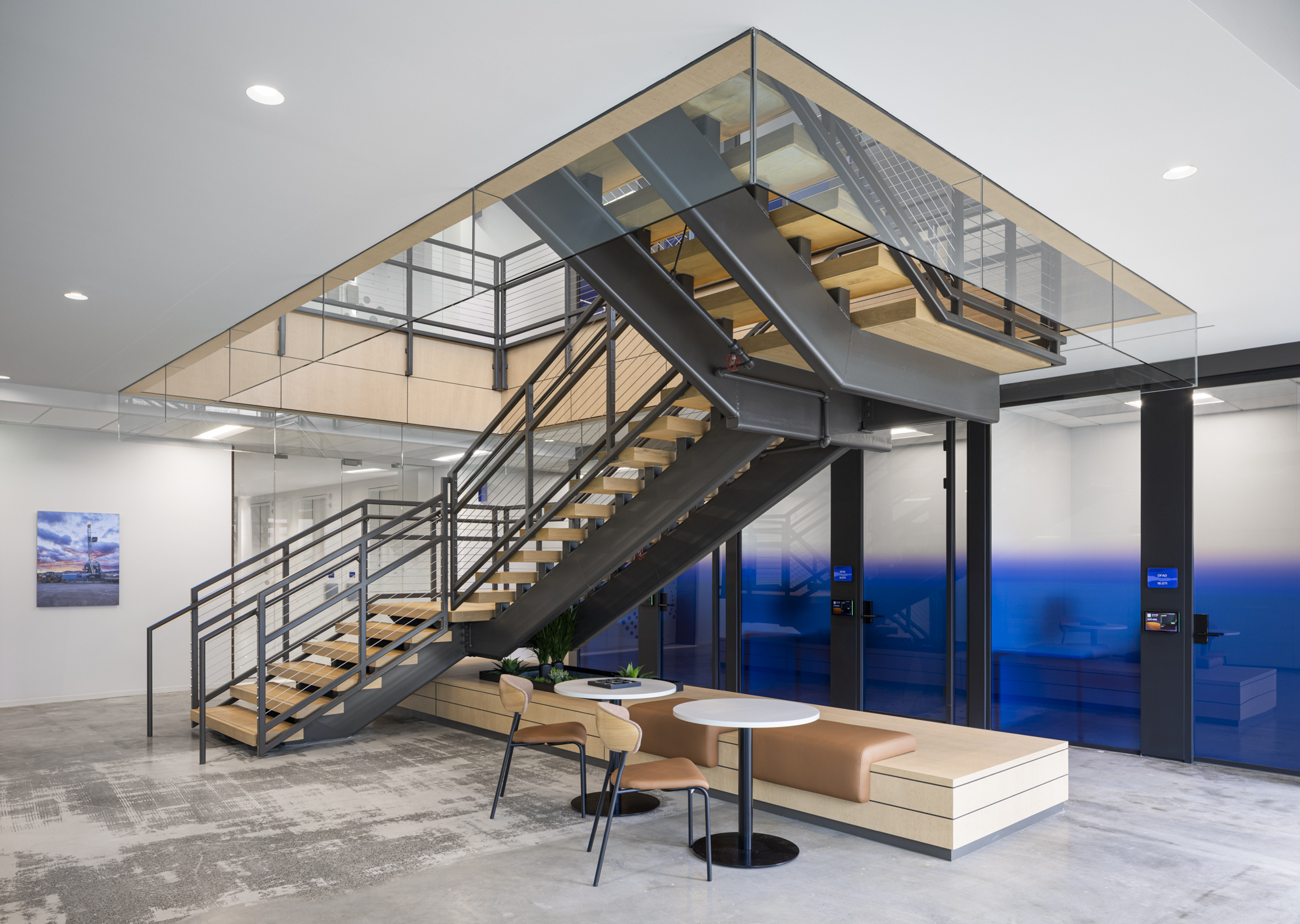 Corporate Interior office private office fronts, and a sitting area under a decorative interconnecting staircase.